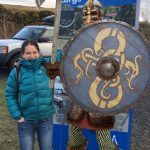 Knight and tourist standing by totem sign, Haylie Brae, Largs