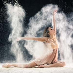 beautiful dancer throwing flour, studio conceptual photo